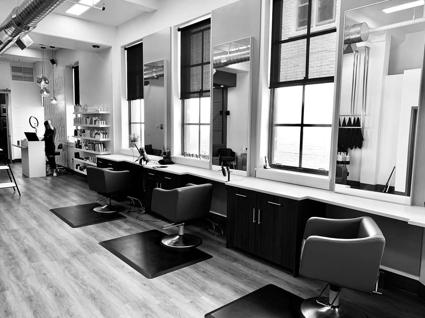 The Eighth Chair studio floor: styling chairs in a row facing tall mirrors and windows.